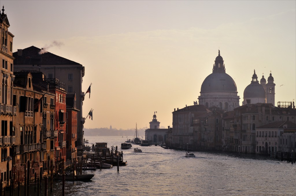 The canals and boats of Venice looking onto the Basilica di Santa Maria della Salute